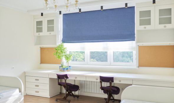 Blue Roman blinds installed in childrens' room