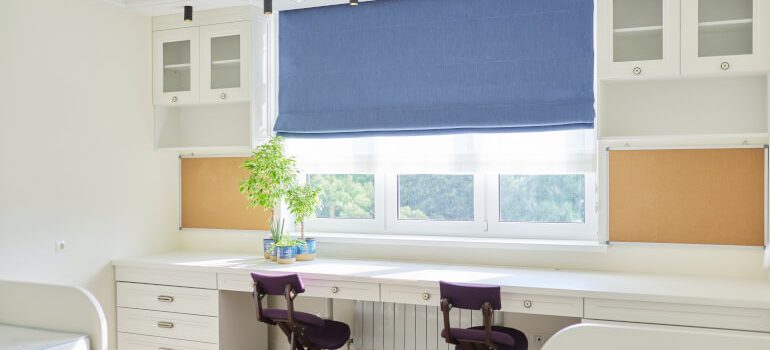 Blue Roman blinds installed in childrens' room